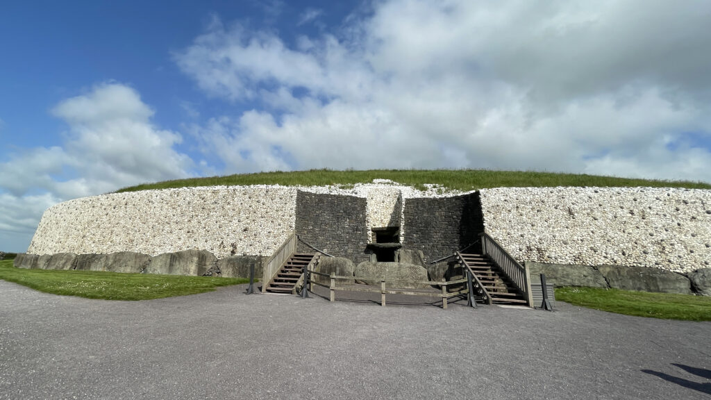 In a shot of Newgrange from last May, you can see the lightbox, where the winter solstice sunrise enters, above the doorway. I was standing in front of the menhir, and its sexy vibes ;-)